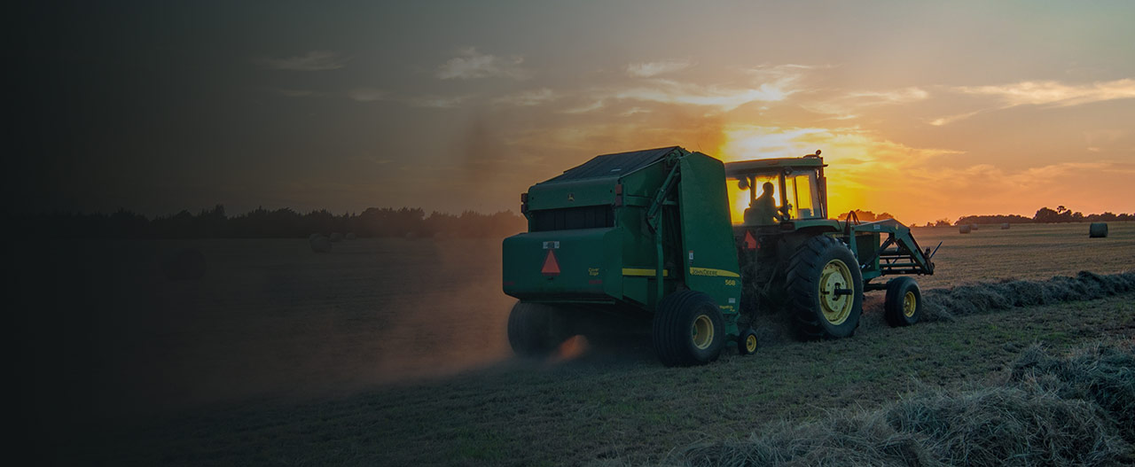 Combine Harvester at sunset